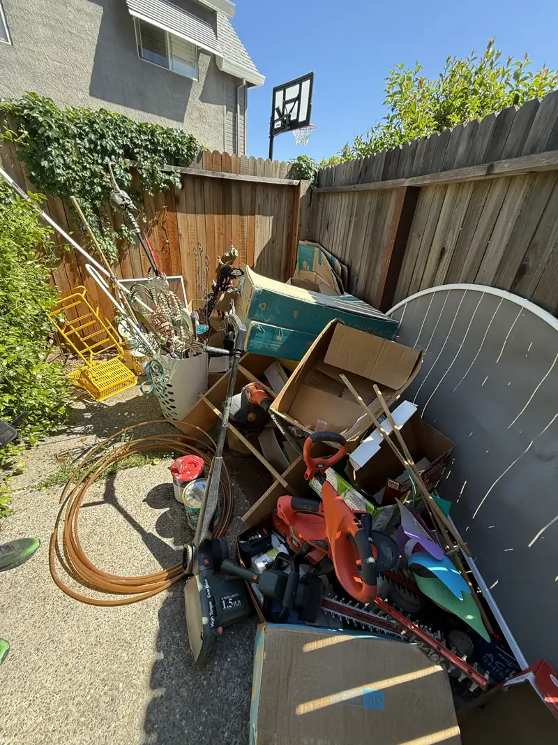 Cluttered junk pile before removal - Job 1