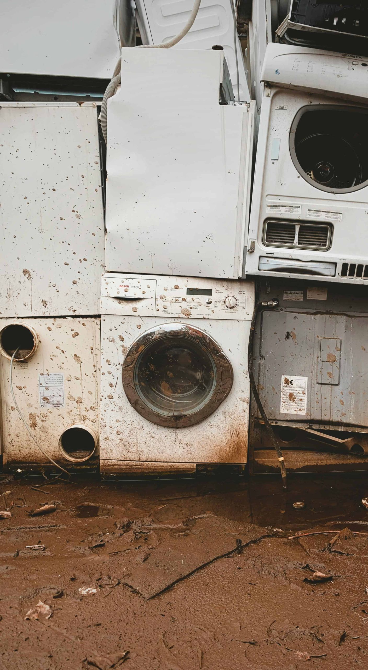 Stack of broken and muddy appliances awaiting eco-friendly removal and disposal in Roseville, CA, by Kale’s Junk & Trash Hauling.